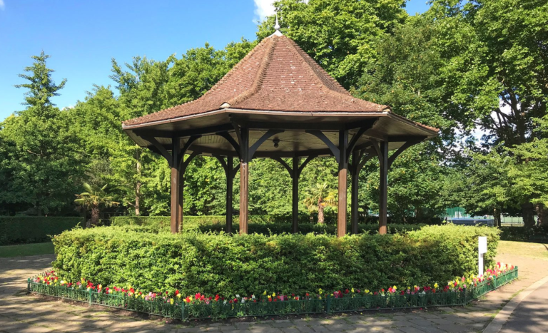 The Bandstand at Paddington Recreation Ground in summer, surrounded by colourful flowers